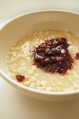 Tasty porridge with raspberries jam for breakfast