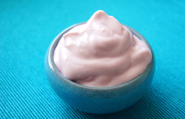 Cherry yogurt for breakfast on turquoise tablecloth