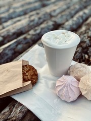 cup of coffee and cookies on wooden table