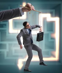 Businessman puppet being manipulated by boss