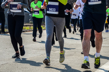 Group legs runners athletes run street of city in Kyiv and Run for Fun 