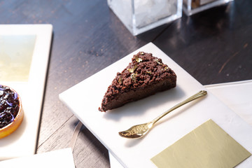 Chocolate cake and Blueberry pie on a marble plate.