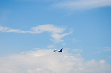Airplane flying overhead with cloudy sky taking off or landing