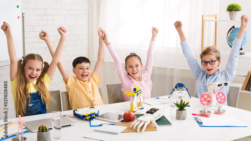 Poster overjoyed children cheering and raising hands at robotics class