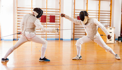 Fencers exercising techniques in battle