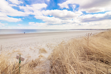 empty, sandy, beach early in morning with clouds 