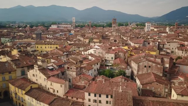 aerial flying over renaissance era walls and medieval terracota city in italy