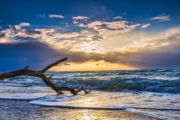colored sunset at the beach - beautiful sunset on the baltic sea with blue sky