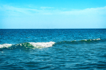 Close up detail view of the blue sea without people. Sea with running wave, blue sky. Rough wave...
