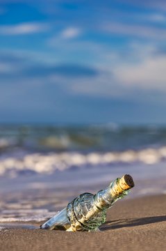  bottle message on the shore line on the baltic sea - old glass bottle with a message on the beach 
