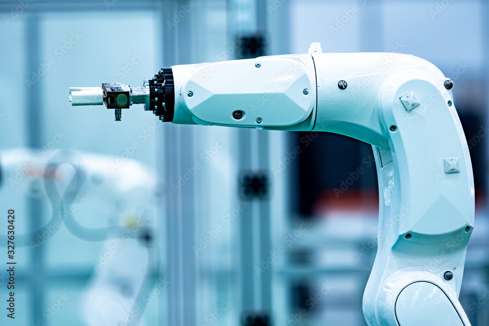 Poster robotic arm with a remote control. white robotic arm. manipulator arm in a technology laboratory. de