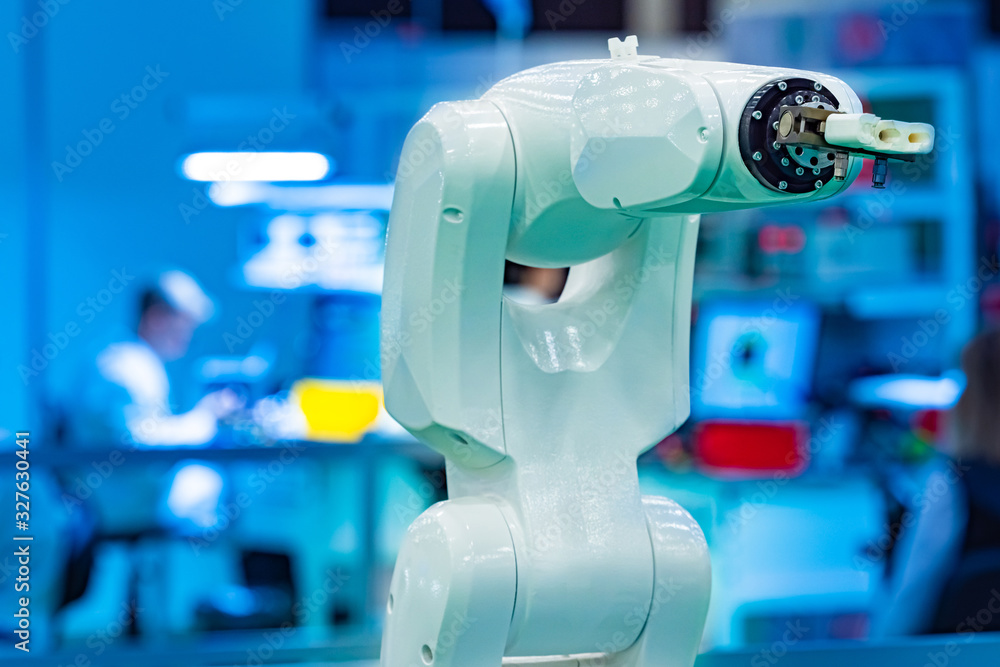Poster development of a manipulator arm. robotic arm on human background. a man remotely controls the arm o