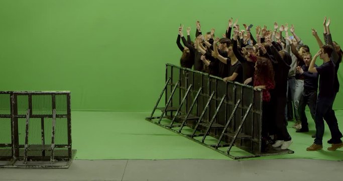 GREEN SCREEN CHROMA KEY Model released, Front view of huge crowd dancing and cheering at a concert or a show behind control barrier. Shot on RED Helium 8K Prores 4444