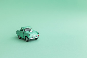 Mint toy car on  the road on a neo mint background