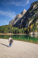 the tourist near famous lake Braies in Italy with Dolomites mountains in background, Pragser wildsee