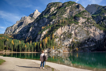the tourist near famous lake Braies in Italy with Dolomites mountains in background, Pragser wildsee