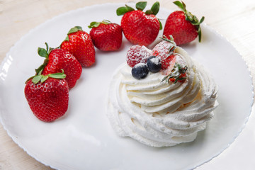Dessert Pavlova  and strawberries on whitre plate