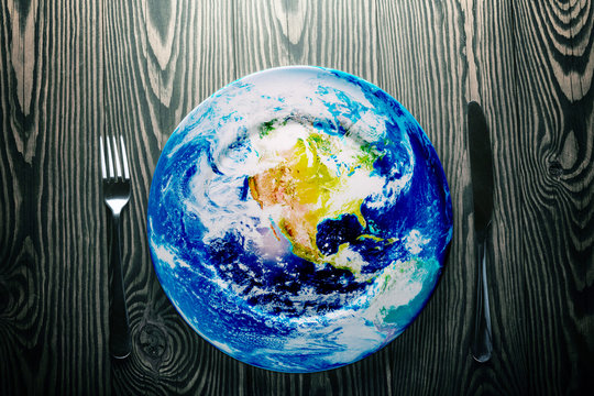 Fresh earth on a plate on an old vintage table. - Powered by Adobe