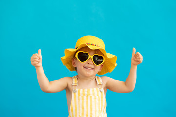 Portrait of happy child against blue background