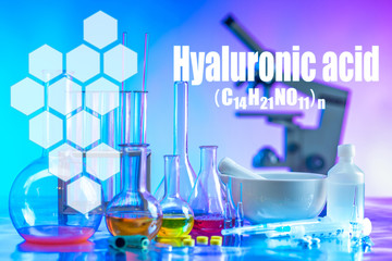 Chemical utensils and microscope on a blue background. Conducting research under a microscope. We learn from our own experience. Medical laboratory. Assessment of the quality of raw materials.
