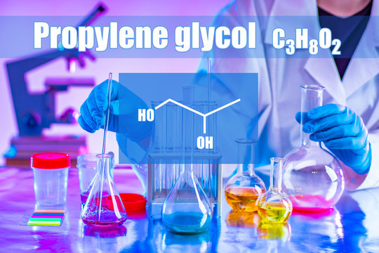 Chemist in a protective suit, glasses and gloves holding test tubes. Testing of potentially hazardous chemical liquids. A man makes an analysis of water samples from the site of contamination.