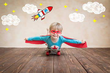 Superhero child on the skateboard