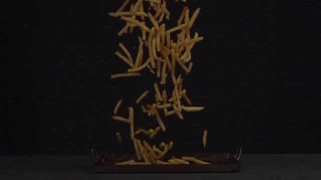 French Fries Falling In 1000fps At Black Background