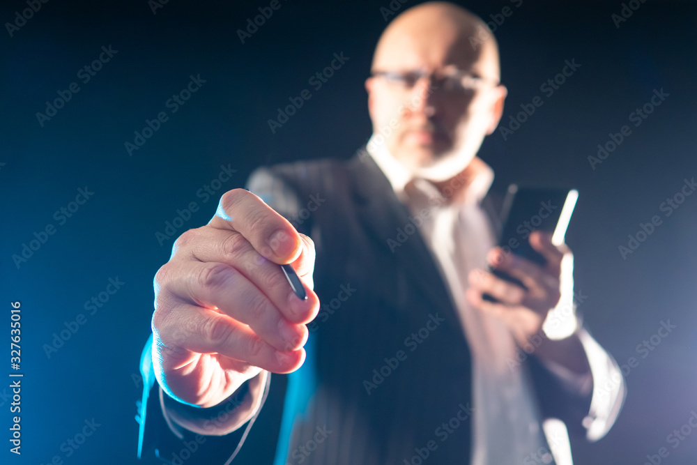 Poster man clicks on the screen. a man in a business suit with a stylus. concept - the boss presses the but