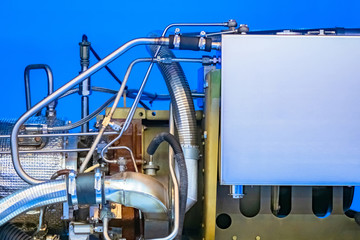 Disassembled screw compressor on a blue background. Electrical equipment. Concept - repair of compressor equipment. Concept - compressor in the enterprise. Sale of electrical equipment