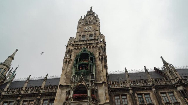 Left to right real time low angle shot of New Town Hall on Marienplatz the city centre of Munich. The town hall are symbols of the city, Munich, Germany.