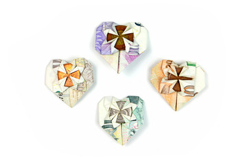 Czech money folded in heart shape on white background