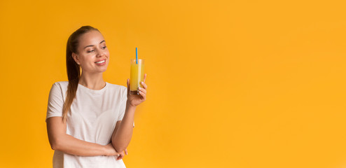 Portrait Of Happy Young Girl Holding Glass Of Orange Juice