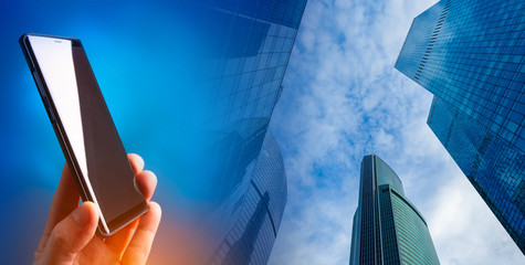 Smartphone on the background of high-rise office buildings. Corporate mobile communications....