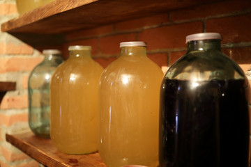 Wine in glass jars on shelf