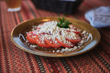 Fresh summer tomato and homemade cheese salad, authentic appetizer salad, vegetarian food.