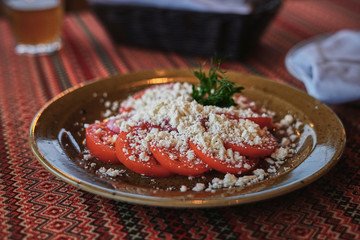 Fresh summer tomato and homemade cheese salad, authentic appetizer salad, vegetarian food.