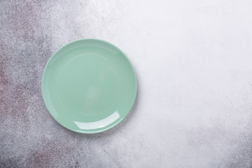 Empty mint plate on stone background. Copy space. Top view