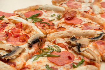 Delicious fresh pizza with cheese, pepperoni, bacon and mushrooms close up on light background for your design