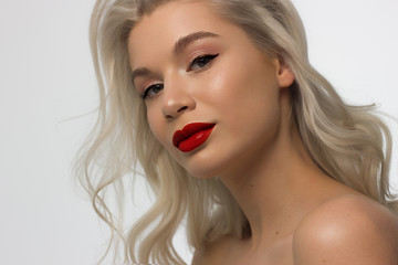 Closeup portrait of a woman with developing straight hair. Sweet tender young girl blonde. Natural lipstick, transparent clean skin. Skin care natural cosmetics in the spa salon or cosmetology.