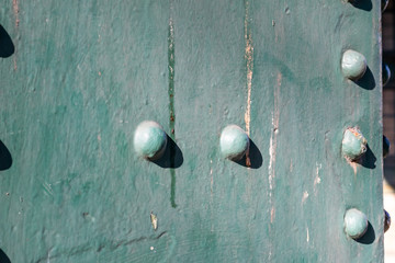 Close up of a section of green painted metal attached to the Tyne Bridge featuring heads of the rivets used to help fix the bridge together.