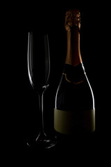 Empty champagne glass tea bottle on black background, magazine and commercial photo with place for text or design, festival and festive food and drink photography