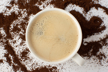 Espresso coffee on a white background with ground coffee. Still-life. Selective focus.