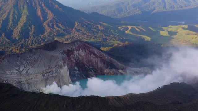 Crater of Ijen volcano, Java, Indonesia. Landscape with the green lake and the smoke