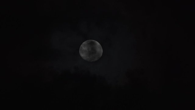Full moon disappearing in the clouds.