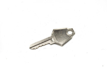 A silver camlock key, close up, isolated on a clean, white background.  Shot in macro.
