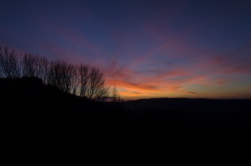 Fototapeta premium Beautiful multicolor sunset over countryside landscape