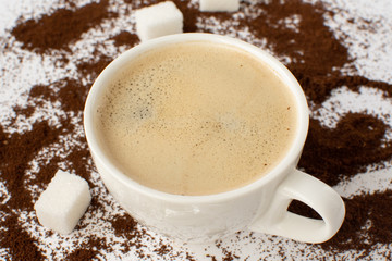 Espresso coffee on a white background with ground coffee. Still-life. Selective focus.