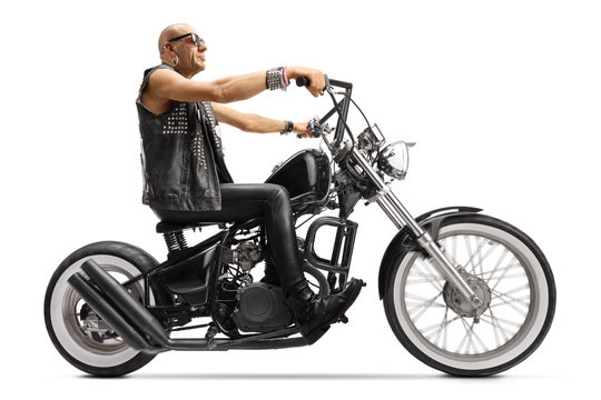 Bald biker riding a custom chopper motorbike