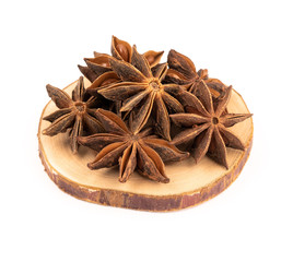 Group of star anise on a wooden cut on a white background