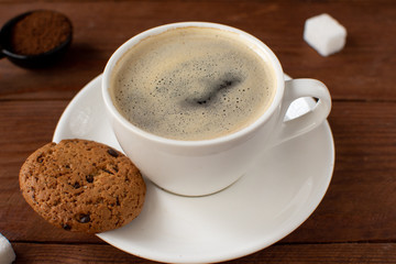 Espresso coffee on a wooden background with cookies. Still-life. Selective focus.